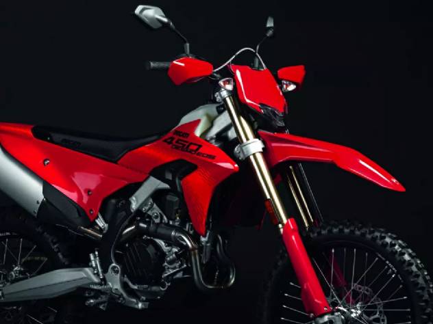 Ducati Desmo450 EDS, motocicleta de enduro off-road vermelha e branca em trilha de terra com paisagem montanhosa ao fundo, destacando seu design agressivo e foco em performance em terrenos desafiadores.