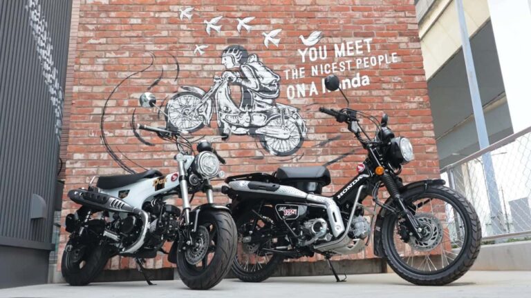 Fachada moderna e convidativa do Honda Cub House no Japão, exibindo motocicletas personalizadas e um ambiente de cafe.