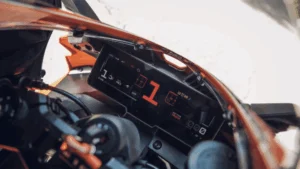 Painel de uma motocicleta KTM moderna, exibindo informações digitais e um guidão em destaque, simbolizando a inovação e o sucesso da marca no mercado.
