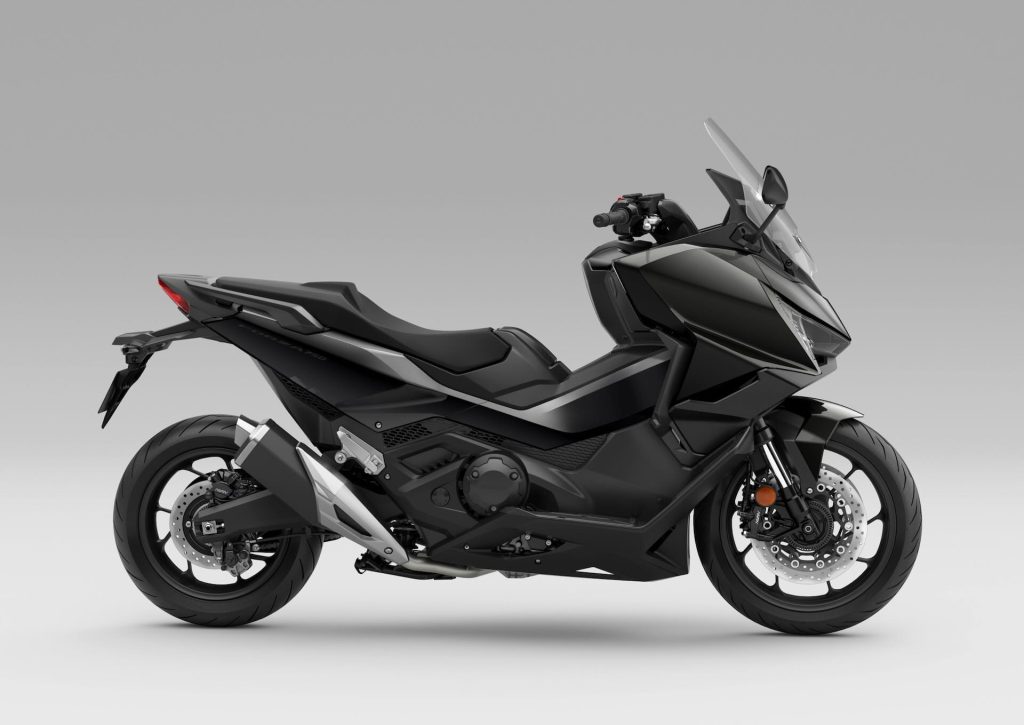 Honda Forza 750 modelo 2027 estacionada em ambiente urbano, exibindo uma das novas opções de cor, destacando seu design sofisticado e linhas esportivas.