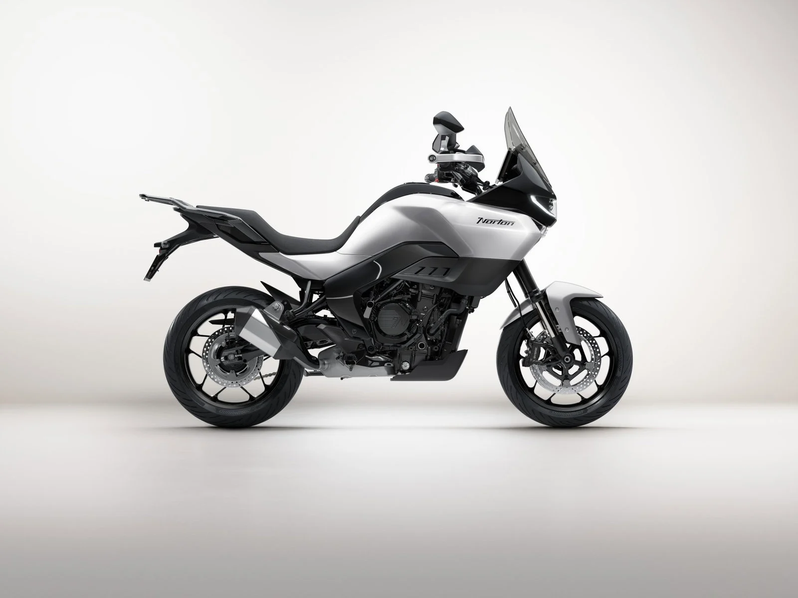Duas motocicletas Norton, a esportiva Manx R e a roadster Atlas, lado a lado, exibindo seu design moderno e as inovações de engenharia.