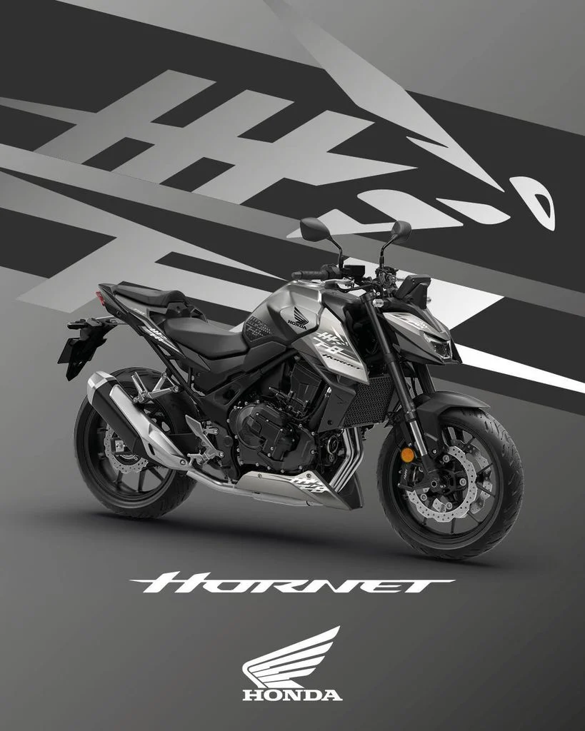 Honda CB750 Hornet 2027 com a nova combinação de cores Prata Mat Beta Metallic e Cinza Iridium Metallic, destacando seu design agressivo e farol duplo LED.