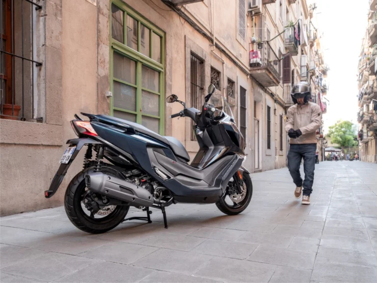 Maxi-scooter KYMCO Downtown GT 350 azul estacionada, destacando seu design moderno, faróis Full LED e rodas de liga leve.