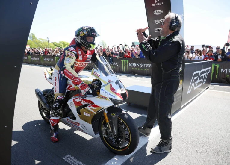 John McGuinness, o 'Morecambe Missile', acelerando sua moto em alta velocidade na Isle of Man TT, mostrando a dedicação e precisão que o tornam uma lenda.