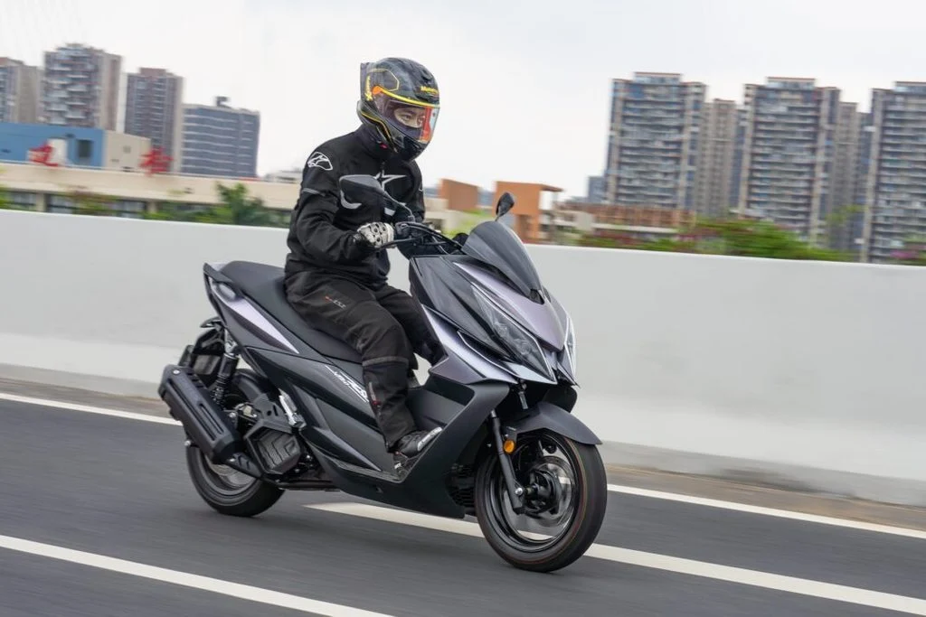 Zontes V125 estacionada em ambiente urbano, exibindo seu design desportivo e moderno, com detalhes tecnológicos visíveis.