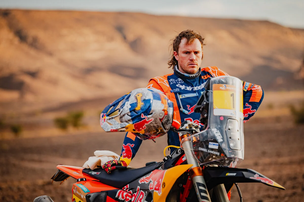 Daniel Sanders pilotando sua moto KTM no Rally de Marrocos 2026 em alta velocidade no deserto, durante a 4ª etapa, com poeira levantando atrás.